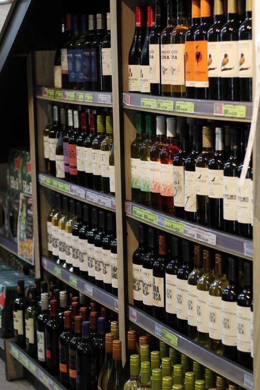 Adega com prateleiras cheias de garrafas de vinho